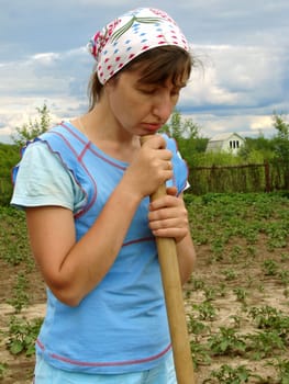 woman with gardening tool working at the farm