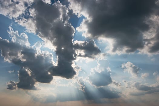 Light rays brightly shining through the clouds