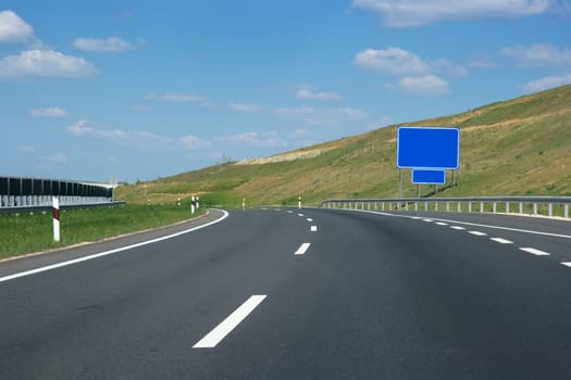 Empty highway lanes bending view from close