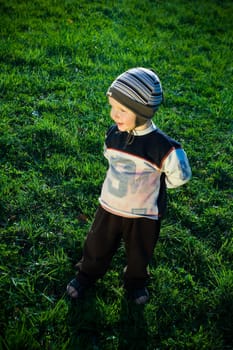 boy standing on a meadow and smiles
