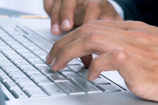Close-up of a businessman's hands typing on the keyboard