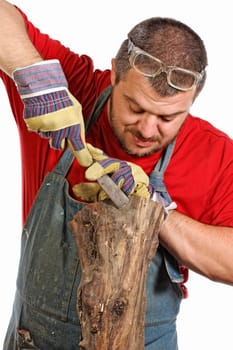 portrait of young man making sculpture from wood