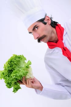 Serious looks Chef holding lettuce vegetable