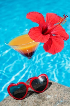 Summer cocktail with red flower and funky sunglasses