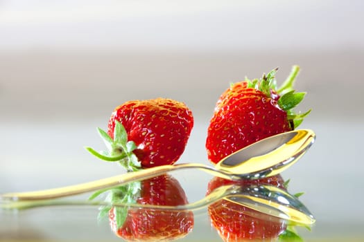food series: two ripe strawberrys and spoon