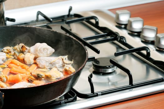 Vegetables fryed in a pan.
