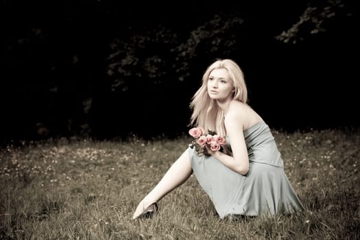 Pretty Woman Sitting OnThe Meadow