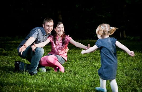 Happy Family Playing On The Grass
