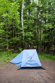Blue Tent in the Woods on a Campsite