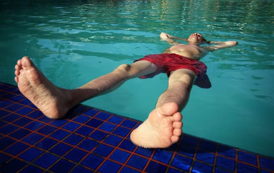 Man enjoying summer in the pool