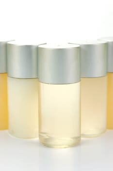 Miniatureshampoo bottles isolated against a white background