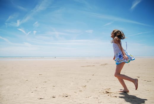 Young girl having fun on the beach
