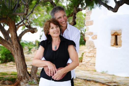 beautiful mature couple holding each other and looking into the distance