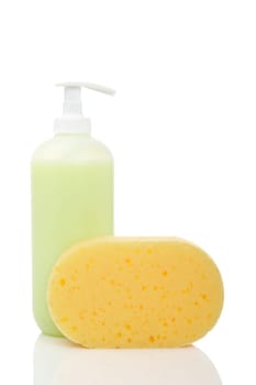 Plastic pump soap bottle and sponge reflected on white background