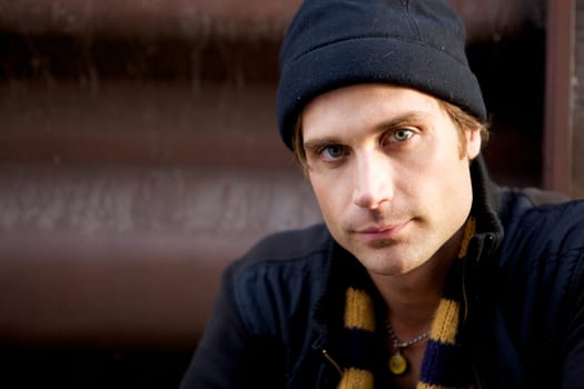 A beautiful young man with a cap and a scarf