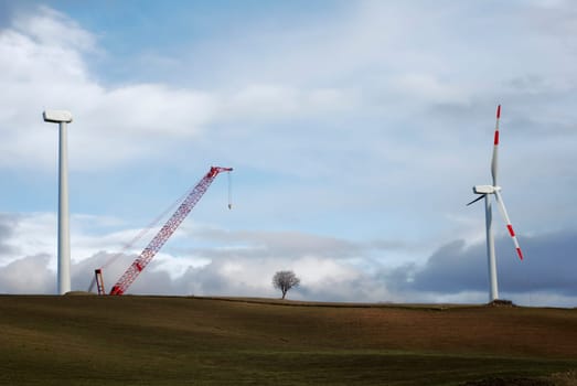 Two wind turbines, one complete and one under construction