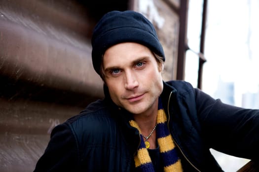 A beautiful young man with a cap and a scarf