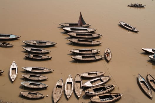 Rowing boats moored in the Ganges river at Varanasi, India.