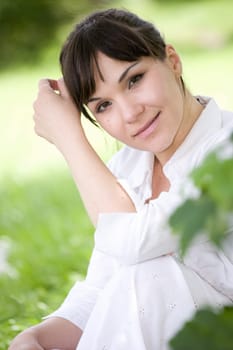 attractive brunette woman relaxing in park