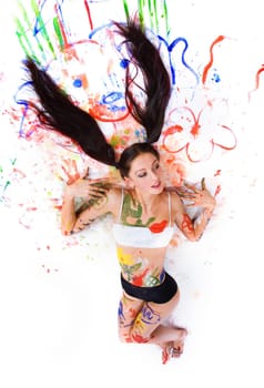 Beautiful girl paints on a white background