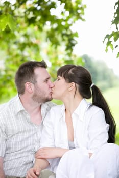 happy young couple relaxing in park