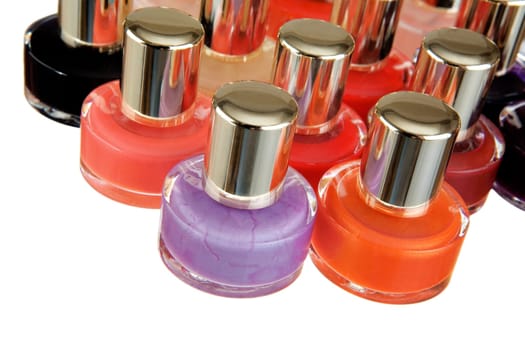 Group of bottles of colour nail polish on a white background