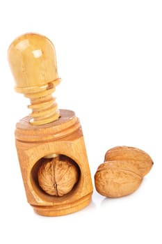 Some walnuts and wood nutcracker reflected on white background
