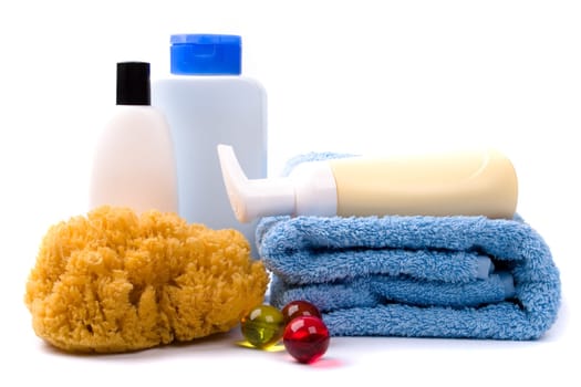 body care products and towel on white background