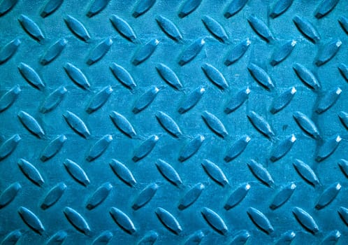 Diamond blue toned metal background texture illuminated by sunlight