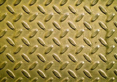 Diamond gold toned metal background texture illuminated by sunlight