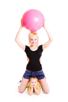 young mother with a big ball and a small son do morning exercises