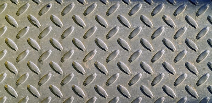Diamond metal background texture illuminated by sunlight