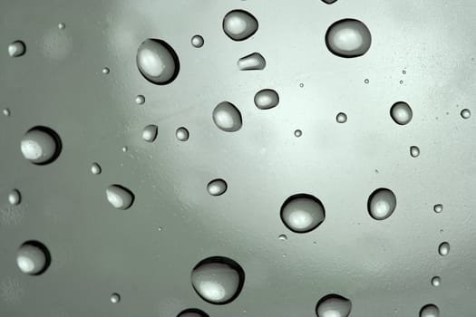 Rain drops on a gray surface