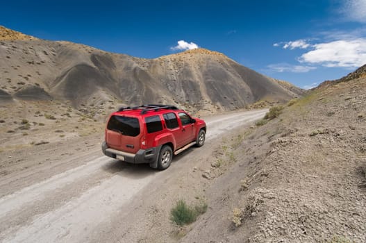 SUV driving the Cottonwood Canyon Road in Grand Staircase Escalante National Park, Utah