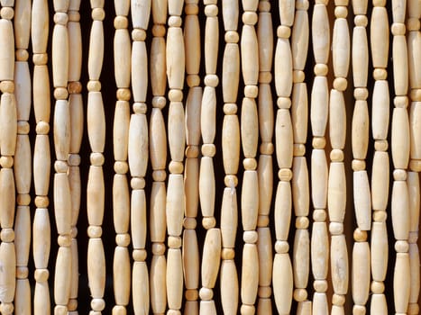 Natural patterns of wooden beeds hanging vertically