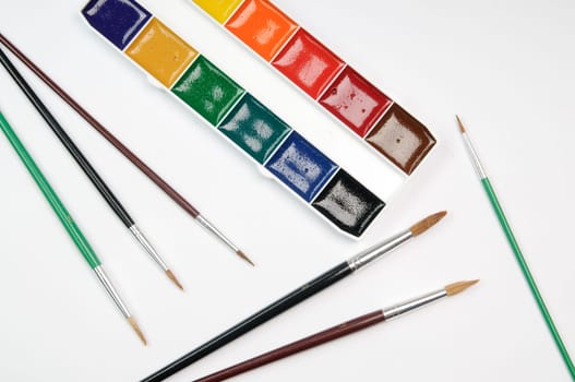 Paintbrushes, paint, and paper
