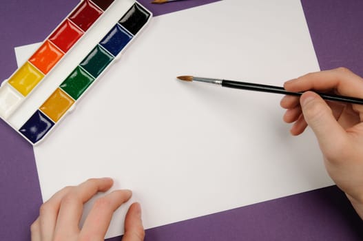 Paintbrushes, paint, and paper