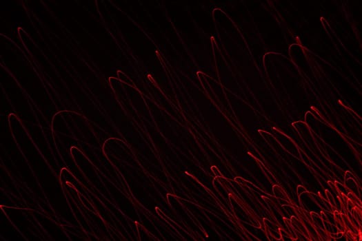 An abstract light background showing motion blurred light on a dark background.