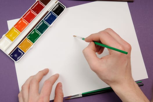 Paintbrushes, paint, and paper