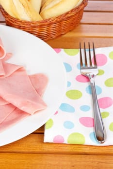 Slices of tasty ham on white dish. Shallow depth of field