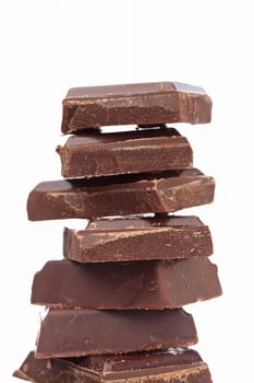 Blocks of chocolate isolated on white background. Shallow depth of field