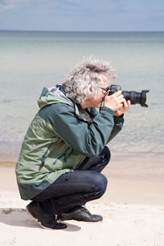 Photographer holding camera taking pictures