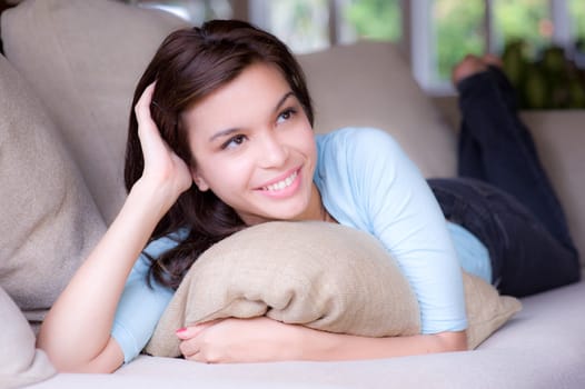 A young attractive woman lying on the sofa at home