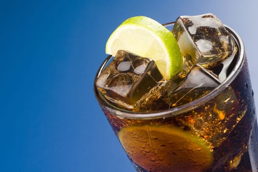 refreshing glass of cola with lemon and ice isolated