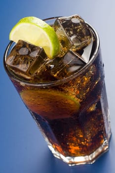 refreshing glass of cola with lemon and ice isolated