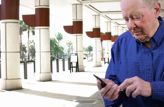 Elderly man  dailing cell phone