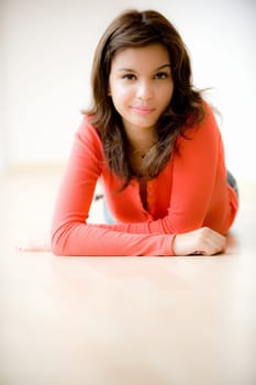 A young woman lying on the floor at home