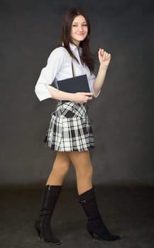 Girl with the book walk on a black background