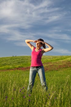 Beautiful young woman on the field looking away
