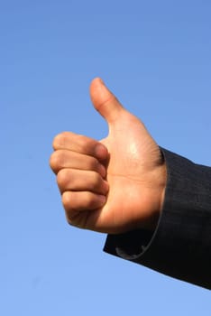 man's hand showing OK! isolated on blue